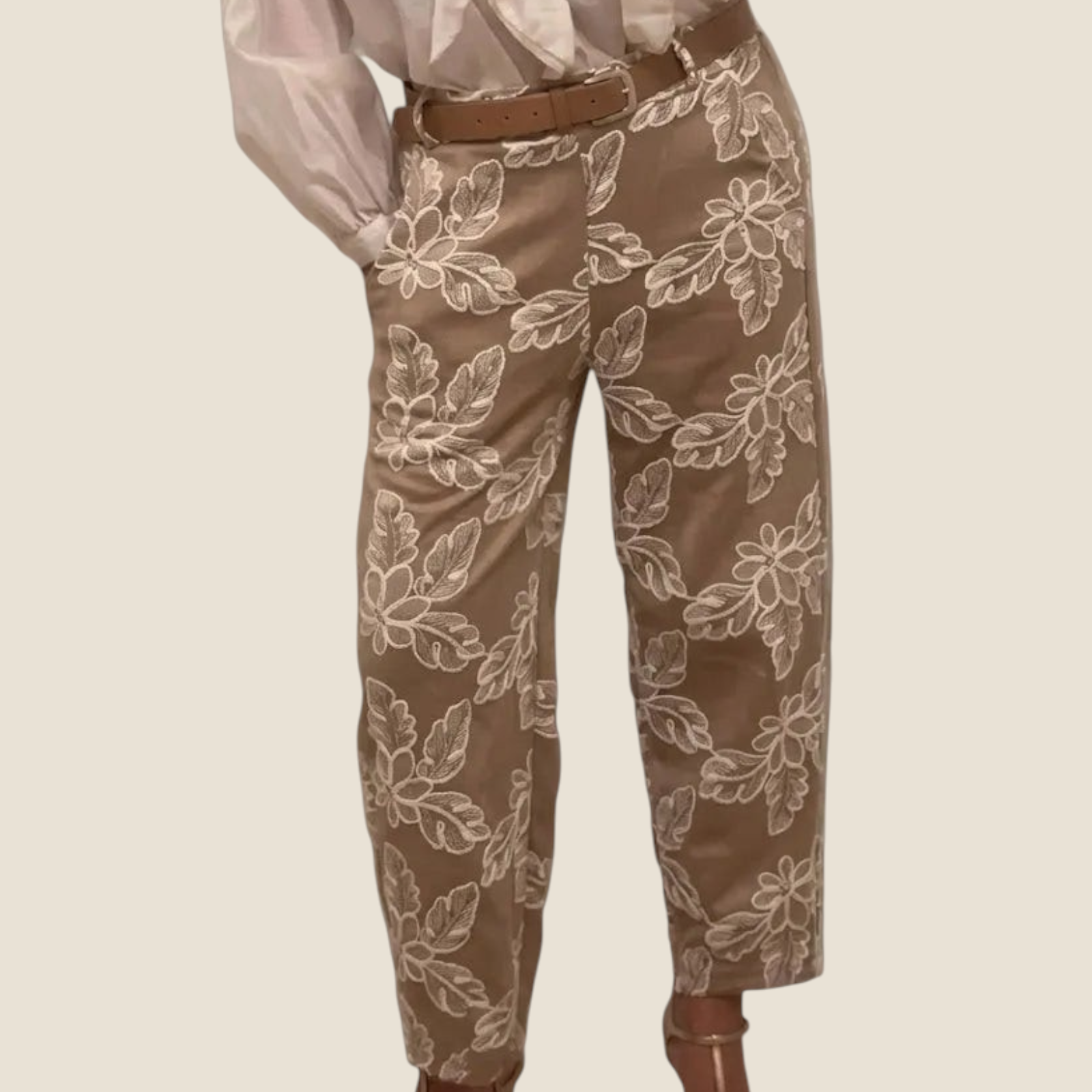 Madison Shop straight leg trousers in beige with white floral embroidery and a brown belt, styled with a white blouse.