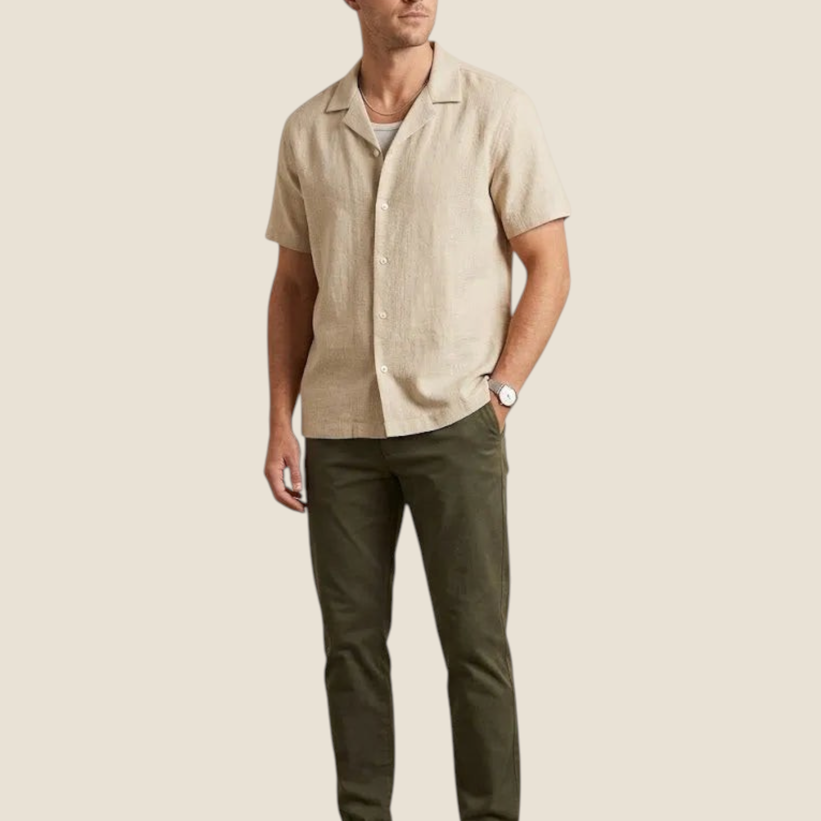 Madison Shop beige short-sleeve shirt with a camp collar, worn by a man with olive trousers and white sneakers.