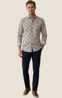 Madison Shop slim fit shirt in earth-toned all-over print cotton and linen blend worn by a man with navy trousers.