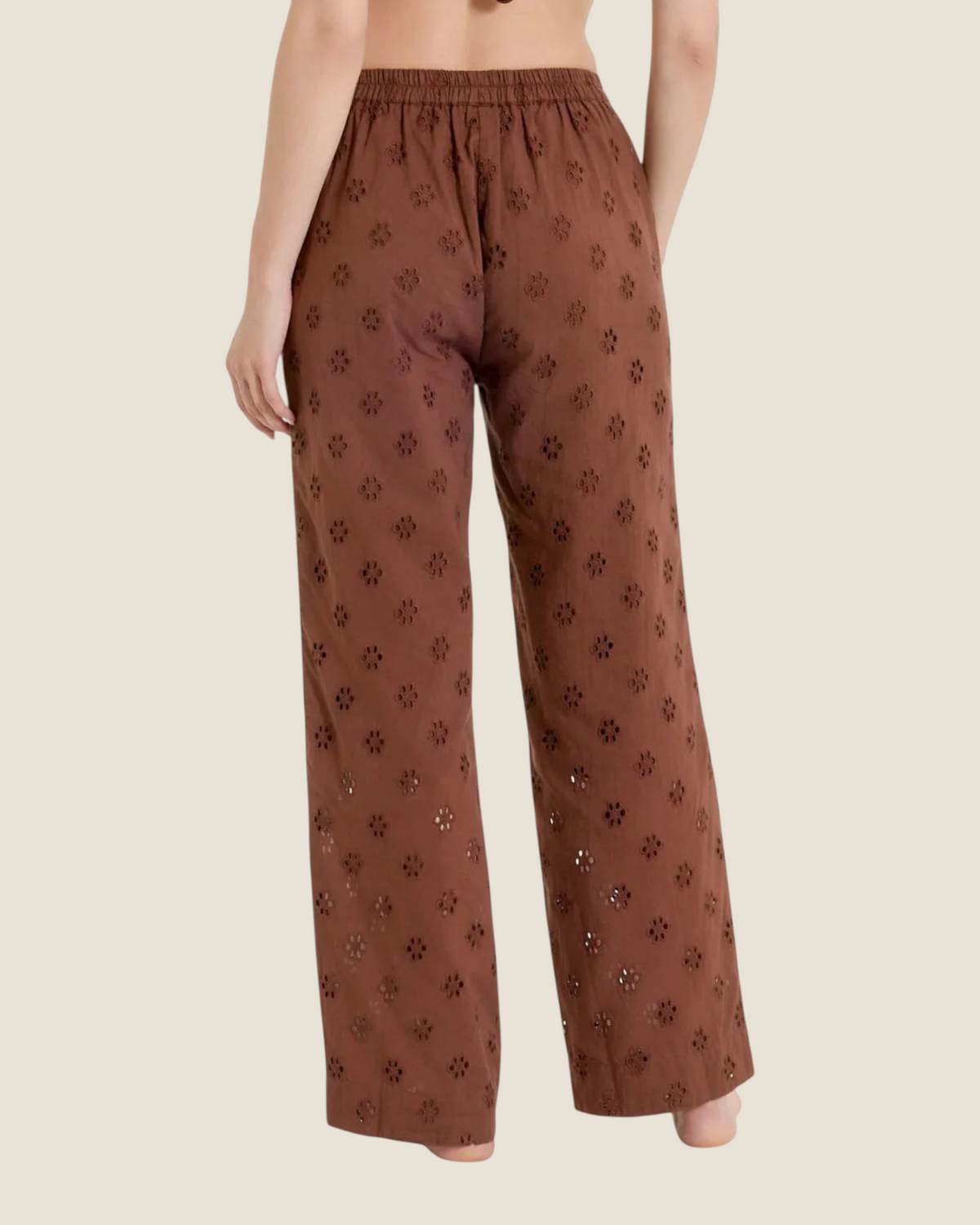Madison Shop brown wide leg trousers in cotton sangallo with an elasticated waist and floral embroidery, back view.
