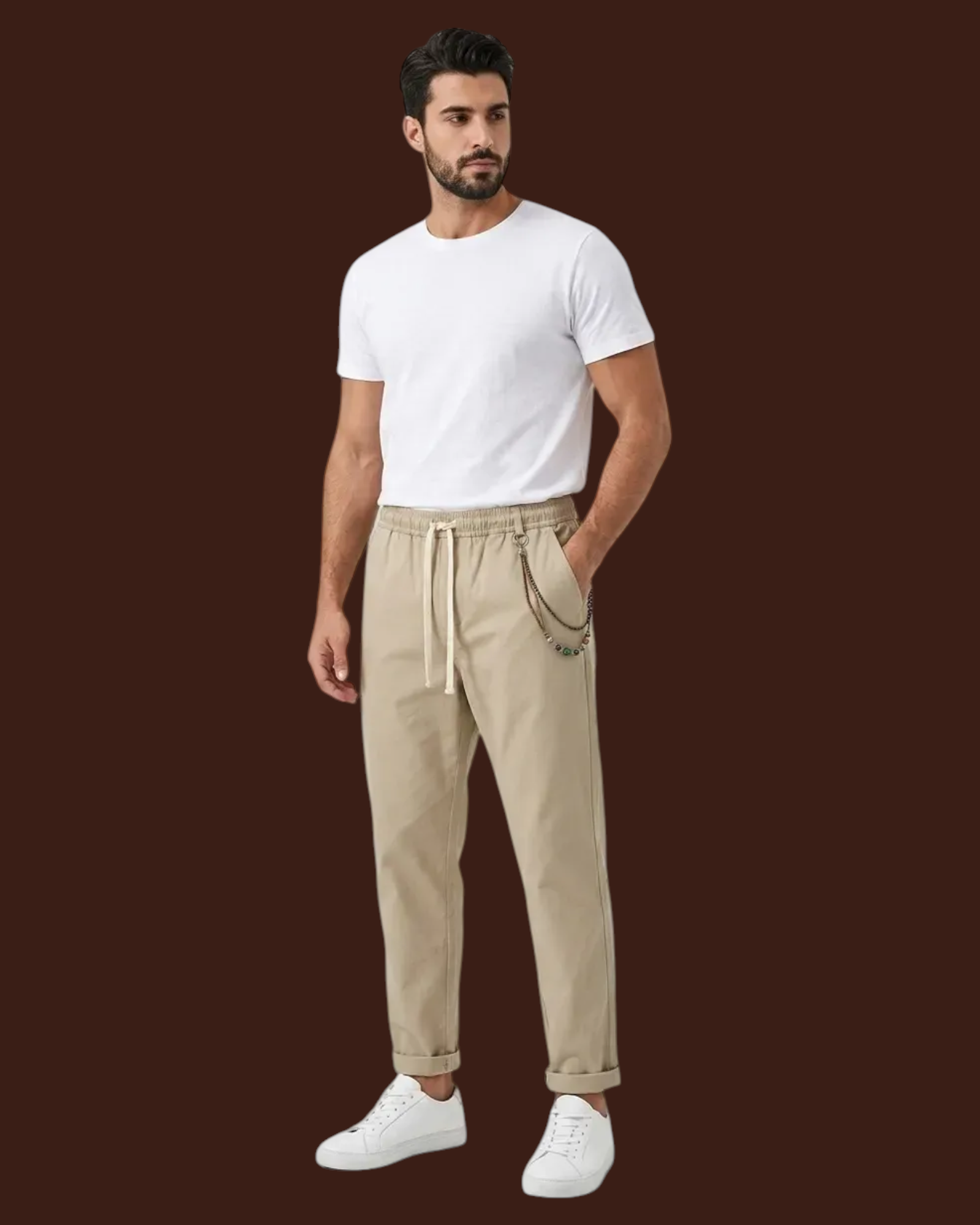 Madison Shop model wearing beige relaxed fit chino pants with elastic waist, drawstring, and chain detail.