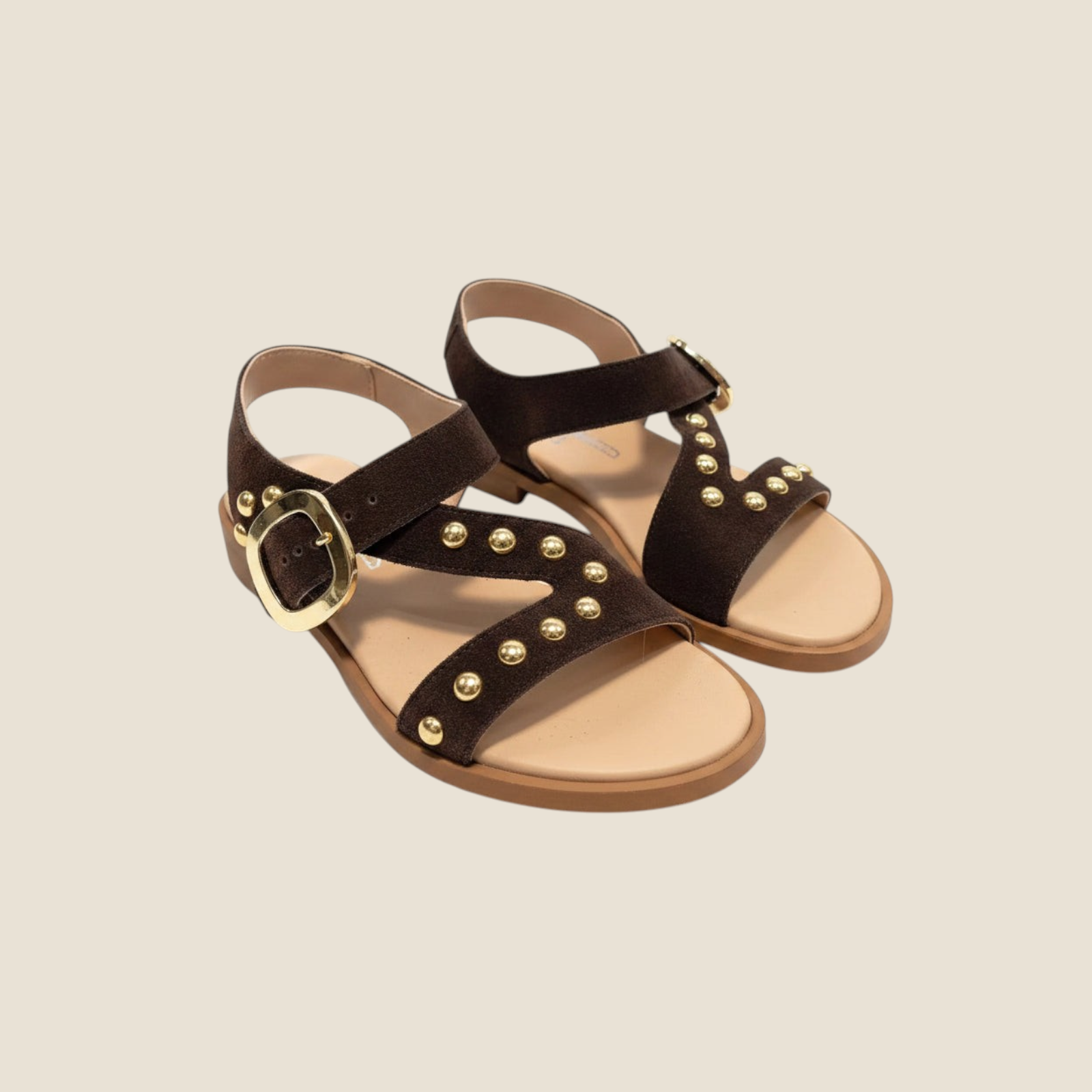 Madison Shop dark brown suede flat sandals with gold spherical studs, crossover straps, and a large buckle closure.