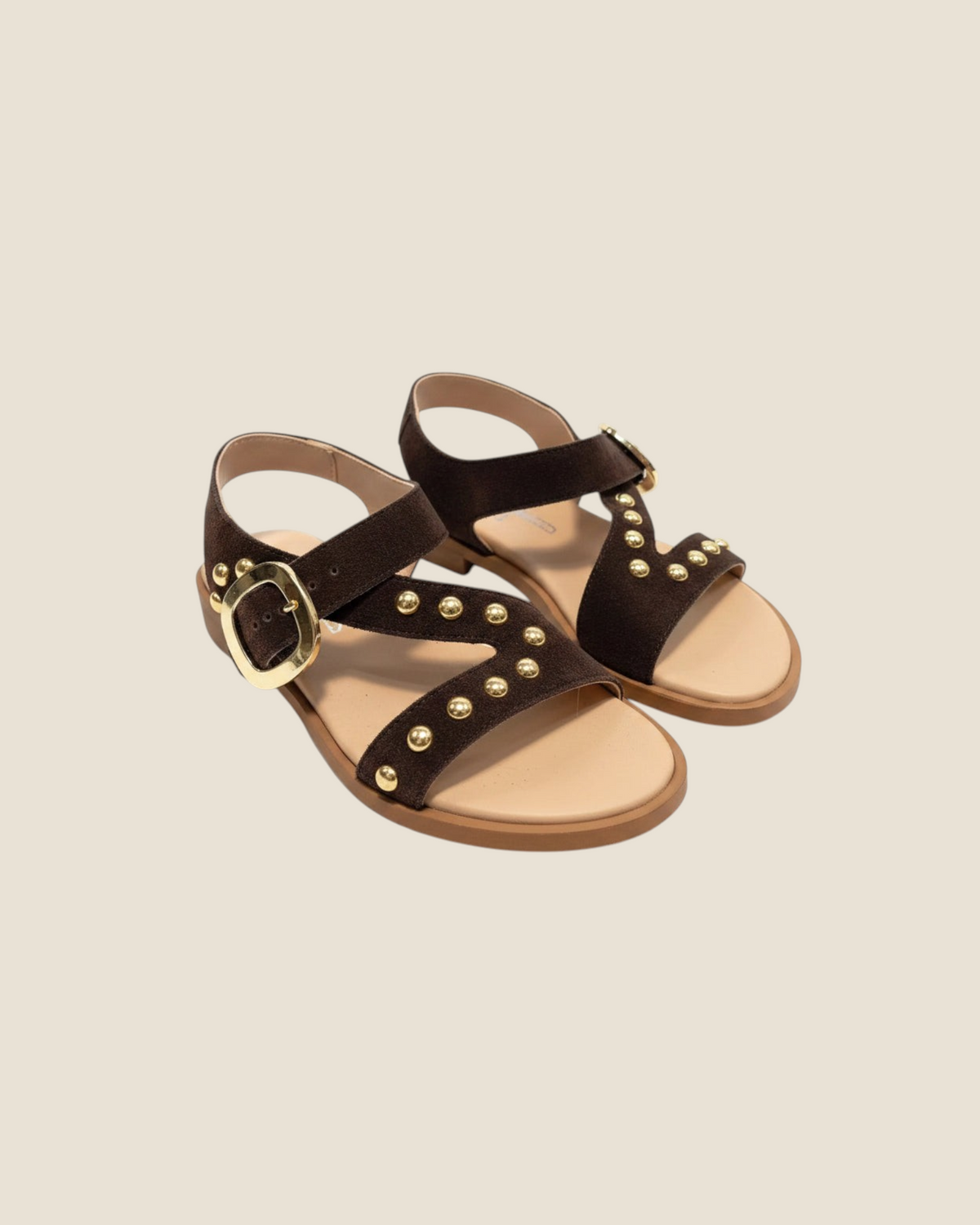 Madison Shop dark brown suede flat sandals with gold spherical studs, crossover straps, and a large buckle closure.