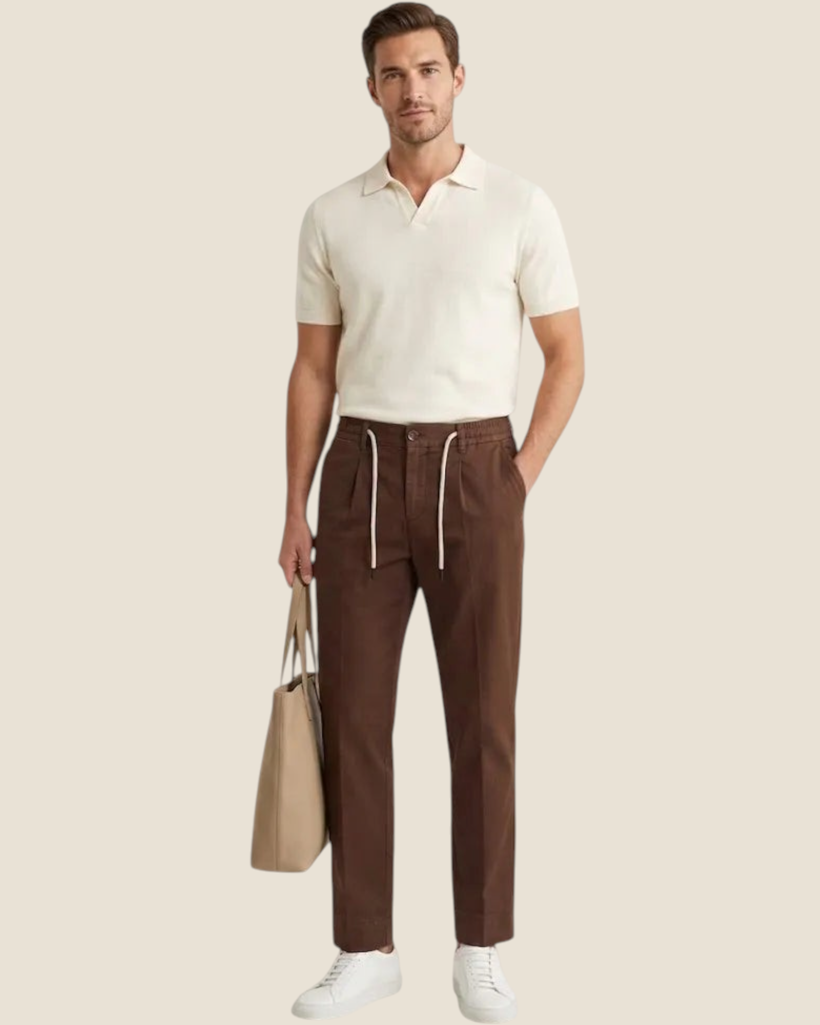 Madison Shop brown cotton chino trousers with front pleats and drawstring waist worn by a man with a beige tote bag